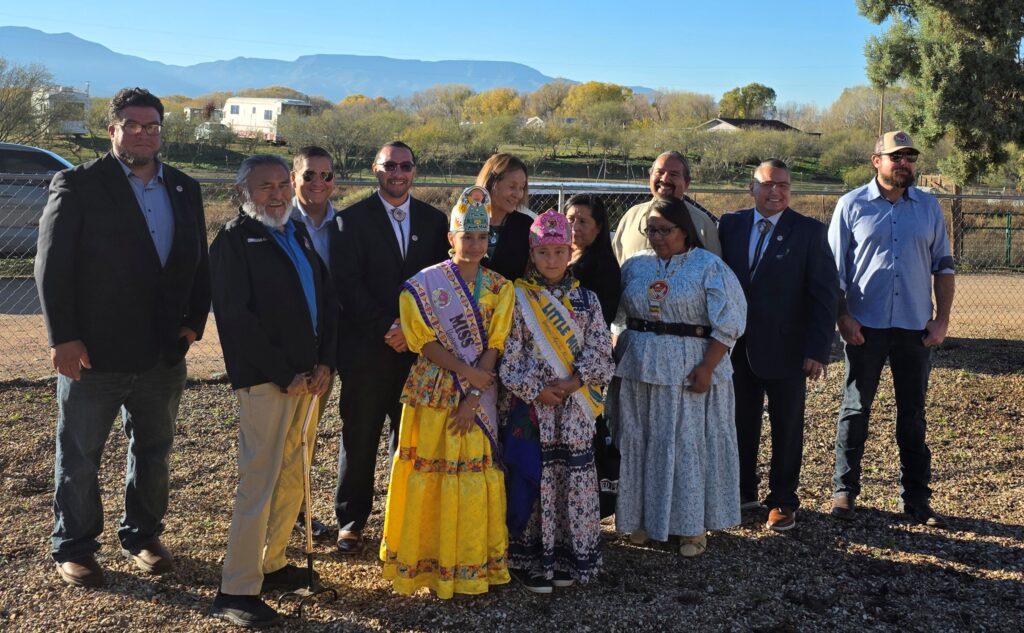 Tribal Council members, Miss Teen, Little Miss, Assistant Secretary Billy Kirkland, and Congressman Eli Crane pose together outdoors at Cloverleaf Ranch at the end of the reception, with the Verde Valley mountains in the background.